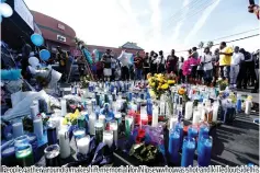  ?? — Reuters photo ?? People gather around a makeshift memorial for Nipsey who was shot and killed outside his clothing store in Los Angeles, California, US, April 1, 2019.