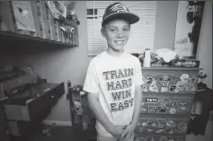  ?? JULIA WALL/RALEIGH NEWS & OBSERVER ?? Braydon Smith, 11, poses for a portrait in his room on Monday. He was home alone on Friday when an attempted robbery occurred in the house where he lives with his father. He chased the suspect off with a machete.