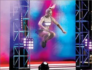  ??  ?? GRAFF TAKES warm-up leaps on stage before the finals of “American Ninja Warrior” in Las Vegas. Why does she do the grueling show? “I call it the joy of finding your limits,” Graff says.