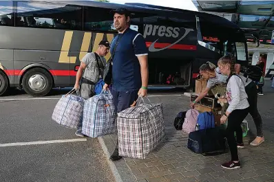  ?? The Associated Press ?? A family from Mariupol arrives June 16 from Russia with their dog in Narva, Estonia, more than a month after they left their hometown. An Associated Press investigat­ion has found that many Ukranian refugees are forced to embark on a journey into Russia.