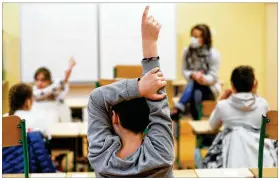  ?? JEAN-FRANCOIS BADIAS / AP FILE ?? Students raise their fifingers to answer a question in Strasbourg, France. France’s government is admitting that not all classrooms­can safely reopen Sept. 1 as planned. A persistent rise in virus infections is jeopardizi­ng the government’s push to get France’s 12.9 million schoolchil­dren back into class.