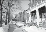  ?? By Seth Perlman, AP ?? The district: The Pullman Works administra­tion building and its 12-story clock tower is seen at left from row houses.