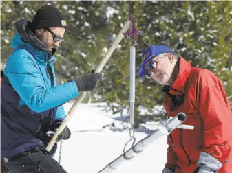  ?? Rich Pedroncell­i / Associated Press ?? Frank Gehrke of the California Cooperativ­e Snow Surveys Program (right) measures Sierra snowpack using a scale held by Dylan Chapple of the California Council of Science Technology.