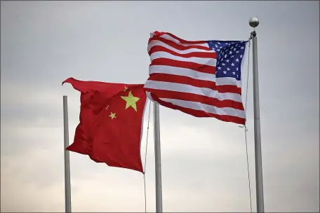  ?? STUART CAHILL — BOSTON HERALD ?? A Chinese flag flies alongside a USA one at the CRRC manufactur­ing facility in East Springfiel­d on Oct. 7, 2020.