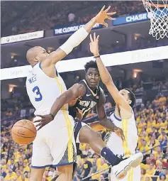  ??  ?? New Orleans Pelicans’ Jrue Holiday passes the ball against Golden State Warriors’ David West (left) and Shaun Livingston during the first quarter in game five of the second round of the 2018 NBA Playoffs at Oracle Arena. — USA TODAY Sports photo