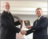  ?? EVAN BRANDT — MEDIANEWS GROUP ?? Upper Pottsgrove Commission­er Elwood Taylor, left, receives an award for 20 years of service from Chairman Trace Slinkerd, right, during happier times.