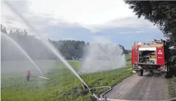  ?? FOTO: THW ?? Die Feuerwehr Neuler sorgte für eine Wasserwand, damit das angenommen­e Feuer nicht auf den angrenzend­en Wald überspring­en konnte.