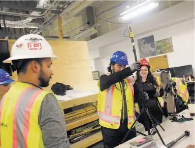  ?? Photos by Lea Suzuki / The Chronicle ?? Mostafa Mo Akbari (center), CEO of HoloBuilde­r, sets up one of the firm’s 360-degree cameras in the San Francisco Internatio­nal Airport office of Hensel Phelps, which is managing the redevelopm­ent of Terminal 1.