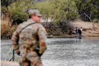  ?? ?? A guardsman stands on the banks of the Rio Grande in Eagle Pass as migrants attempt to cross from Mexico last week.