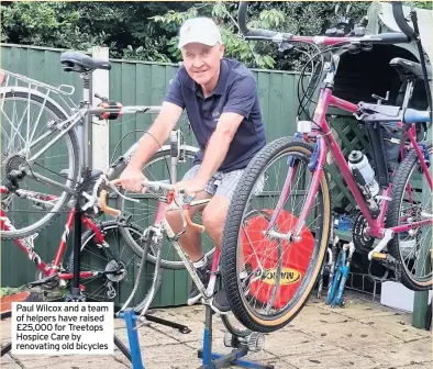  ??  ?? Paul Wilcox and a team of helpers have raised £25,000 for Treetops Hospice Care by renovating old bicycles