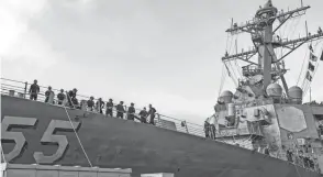  ?? SPC. JASON PASTRICK/U.S. NAVY VIA AP, FILE ?? Sailors aboard the guided missile destroyer USS Stout handle mooring lines during the ship’s return to home port at Naval Station Norfolk in Virginia. Ships are spending more time in ports because of growing maintenanc­e delays and costs, a new report says.