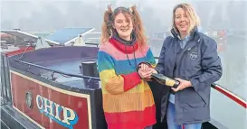  ?? PHOTO: TIM COGHLAN ?? Braunston Marina narrowboat sales manager Victoria Garfield presents circus performer Finley Guy with a bottle of Prosecco following her purchase of narrowboat Chip – the marina’s first completed sale of 2022.