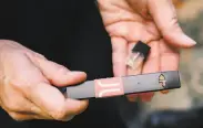  ?? Michael Short / Special to The Chronicle ?? School nurse Lynda BoyerChu of Washington High in San Francisco uses a Juul vaporizer and cartridge to teach students about vaping’s risks.