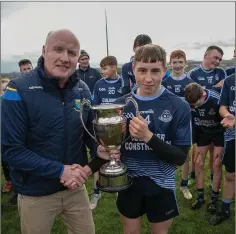  ??  ?? Michael Dwyers captain Charlie Shamley is presented with the cup by Coiste na nÓg Chairman Pat Dunne.