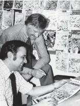  ?? Associated Press ?? ■ Stan Lee, standing, publisher of Marvel Comics, discusses a "Spider-Man" comic book cover with artist John Romita at Marvel headquarte­rs in this Jan. 10, 1976, file photo.