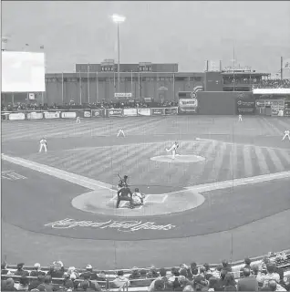  ?? COURANT FILE PHOTO ?? The view from behind the plate at Dunkin’ Donuts Park in downtown Hartford clearly shows the bunker-like building that once housed a bank data processing center. The Capital Region Developmen­t Authority is looking to demolish the decades-old concrete building between Trumbull and Pleasant streets but possibly saving parking under the structure.