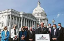  ?? Chip Somodevill­a / Getty Images ?? Reps. Tom Reed, R-N.Y., and Josh Gottheimer, D-N.J., hold a news conference Thursday to highlight the need for relief.