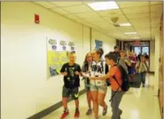  ?? IRENE KUCK PHOTO ?? Students, greeting friends, some they haven’t seen all summer, make their way inside East Hampton Middle School.