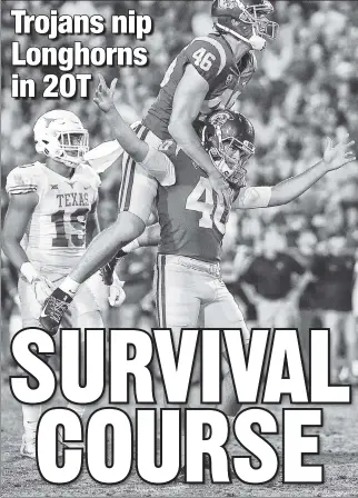  ?? AP ?? HOLLYWOOD ENDING: USC’s Wyatt Schmidt jumps on kicker Chase McGrath’s shoulders after McGrath kicks the game-winning field goal Saturday against Texas.