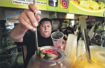  ?? Photograph­s by Kirk McKoy Los Angeles Times ?? EFRAIN PEÑA runs Highland Park juice shop Jugos Azteca with his family, serving tortas and tostadas too.