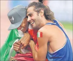  ??  ?? Mutaz Essa Barshim of Qatar and Gianmarco Tamberi of Italy after winning gold.