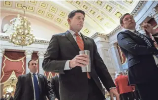  ?? J. SCOTT APPLEWHITE/AP ?? House Speaker Paul Ryan walks to his office Thursday on Capitol Hill as he and the Republican leadership scramble for votes on their health care overhaul.