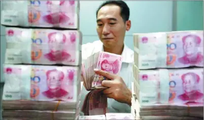  ?? XIE ZHENGYI / FOR CHINA DAILY ?? China’s total social financing aggregate, a broad measure of liquidity in the economy, was 856.4 billion yuan in October, compared with 1.4 trillion yuan the month before.