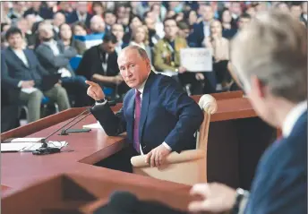  ?? AP PHOTO ?? Russian President Vladimir Putin gestures as he looks at his spokesman Dmitry Peskov during an annual news conference in Moscow, Russia.