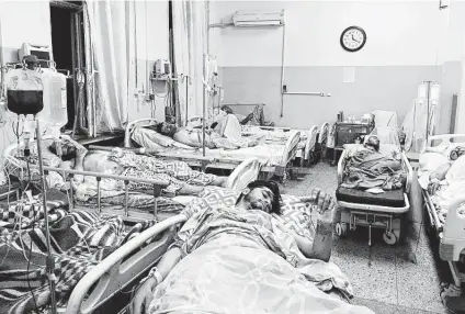  ?? Mohammad Asif Khan / Associated Press ?? Afghans lie in hospital beds after they were wounded in deadly attacks near the airport in Kabul, Afghanista­n.