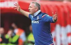  ?? AFP ?? Stoke City’s manager Paul Lambert shouts instructio­ns to his players from the touchline during a match against Burnley.