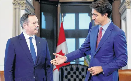  ?? REUTERS/CHRIS WATTIE/FILE PHOTO ?? Canada’s Prime Minister Justin Trudeau reaches out to shake hands with Alberta Premier Jason Kenney during a meeting in Trudeau’s office on Parliament Hill in Ottawa May 2, 2019.