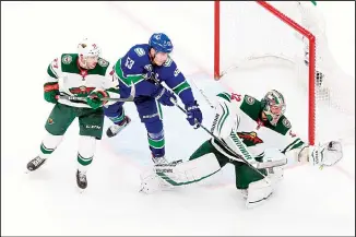  ?? (AP) ?? Minnesota Wild goaltender Alex Stalock (32) makes a save against Vancouver Canucks’ Bo Horvat (53) as Wild’s Brad
Hunt (77) defends during the second period of an NHL hockey playoff game in Edmonton, Alberta on Aug 4.