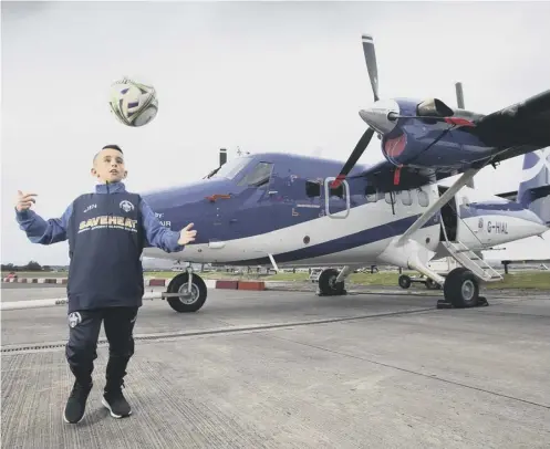  ??  ?? 0 Mon the Ton: Matthew Davidson flies in from Barra every week to play for Morton’s under-11 side, with help from airline Loganair