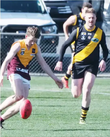  ??  ?? Another young player on his way up at Drouin Jye Mitchell gets a clearing kick from defence during the reserves match at Morwell on Saturday.