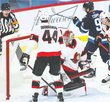  ?? TERRENCE LEE / USA TODAY SPORTS ?? Winnipeg Jets forward Andrew Copp, right, scores the second of his two third-period goals against Ottawa Senators goalie Marcus Hogberg Saturday at Bell MTS Place in Winnipeg. The Jets entered the period trailing 3-2 and finished the frame with a 6-3 victory.