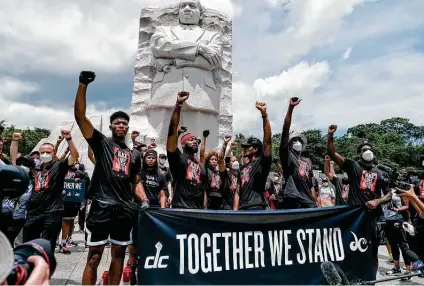  ?? Michael A. McCoy / Getty Images ?? Washington Wizards and Washington Mystics players rally at the MLK Memorial on Juneteenth to support the Black Lives Matter movement. Players union president Chris Paul says to expect more of the same in Orlando: “It’s never a shut up and dribble situation.”