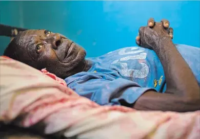  ?? JEROME DELAY
THE ASSOCIATED PRESS ?? Gabriel Mutamba lies on his hospital bed at a hospital in Lubumbashi. Mutamba first came to the hospital in 2017 with a broken leg. Though doctors fixed his leg, he then developed other problems. While he’s now stable enough to leave, he’s also racked up a substantia­l bill and hospital officials have so far refused to discharge him.