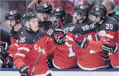  ?? FRANK GUNN/THE CANADIAN PRESS ?? Canada forward Curtis Lazar celebrates with teammates after scoring on Denmark during first-period quarter-final action at the world junior hockey championsh­ips in Toronto on Friday. The final score was 8-0 for the hosts.