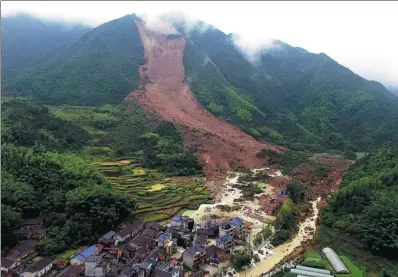  ?? DONG XUMING / FOR CHINA DAILY ?? Sucun village was hard hit by a landslide at 5:30 pm on Wednesday. Thirteen people have been rescued, three were confirmed dead and about 20 were still missing as of Thursday evening.