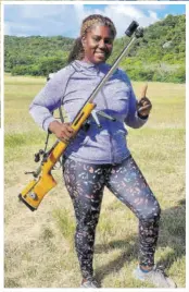  ?? ?? Jamaican Amazon Cup winner Nicola Guy poses with a Full Bore rifle. She won her first Amazon Cup for top female at the West Indies Full Bore Shooting Championsh­ip in Antigua & Barbuda recently.