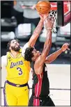  ??  ?? Los Angeles Lakers forward Anthony Davis blocks a shot by Miami Heat forward Jimmy Butler during the second half in Game 4 of basketball’s NBA Finals, Oct 6, in Lake Buena Vista, Florida. (AP)