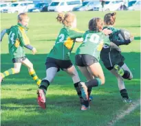  ??  ?? This St Joseph’s Midgets player has plenty of attention from her Puketoi opponents