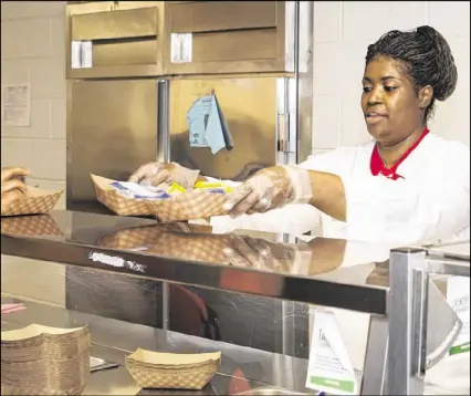  ?? CONTRIBUTE­D ?? Rachel Cooper manages the cafeterias at Jean Childs Young Middle and L.P. Miles Elementary schools in southwest Atlanta. Her favorite part is getting to know the students she feeds.