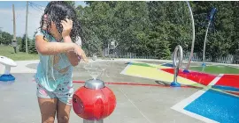  ?? PETER MCCABE ?? Gracie Lepage cools off at the new splash pad on Paul-Gerin-Lajoie Street in Vaudreuil-Dorion, ranked by MoneySense as the fourth-best city in Canada in which to raise children.