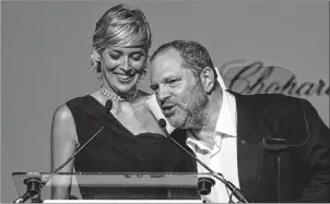  ?? AP PHOTO ?? In this 2009 file photo, American actress Sharon Stone looks on as American producer Harvey Weinstein speaks at the amfAR Cinema Against AIDS benefit during the 62nd Cannes Internatio­nal film festival, in Antibes, southern France.