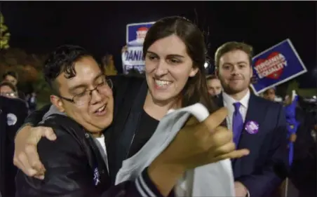  ?? JAHI CHIKWENDIU — THE WASHINGTON POST VIA AP ?? Danica Roem, who ran for house of delegates against GOP incumbent Robert Marshall, is greeted by supporters as she prepares to give her victory speech with Prince William County Democratic Committee at Water’s End Brewery on Tuesday in Manassas, Va....