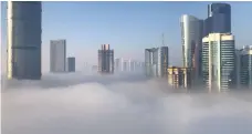  ?? Pawan Singh / The National; Carla Karim ?? Clockwise from above right, early morning fog in Dubai; walkers fade to grey; and high-rise buildings on Reem Island, Abu Dhabi, are cut in half by the clouds