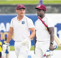  ?? AP ?? West Indies batsmen Joshua Da Silva (left) and Nkrumah Bonner walk back to pavilion as the play stopped due to bad light during the fourth day’s play of the first Test cricket match against Sri Lanka in Galle, Sri Lanka, yesterday.