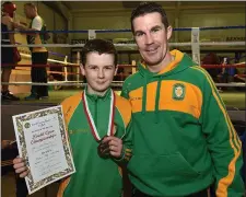  ??  ?? Adam Mc Kenna (Holy Family BC), winner of the Boy 2 37kg title, with his proud dad Damien who is one of the club’s coaches.