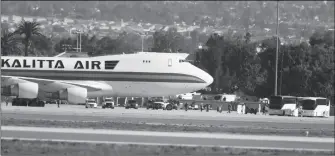  ?? ASSOCIATED PRESS ?? PASSENGERS BOARD BUSES AFTER ARRIVING ON AN AIRPLANE carrying U.S. citizens being evacuated from Wuhan, China, at March Air Reserve Base in Riverside, Calif., on Wednesday. The passengers will undergo additional screenings in California and be placed in temporary housing. Officials have not said how long they will stay there.